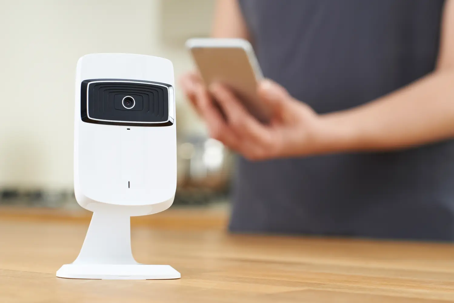 Smart camera, a person in the background is holding a smartphone