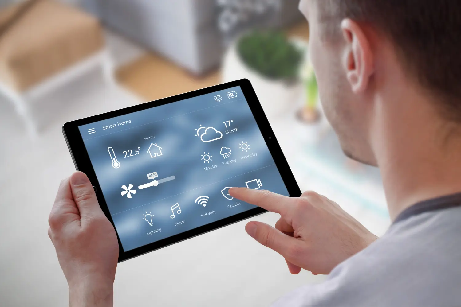 A man holding a tablet with Smart Home controls