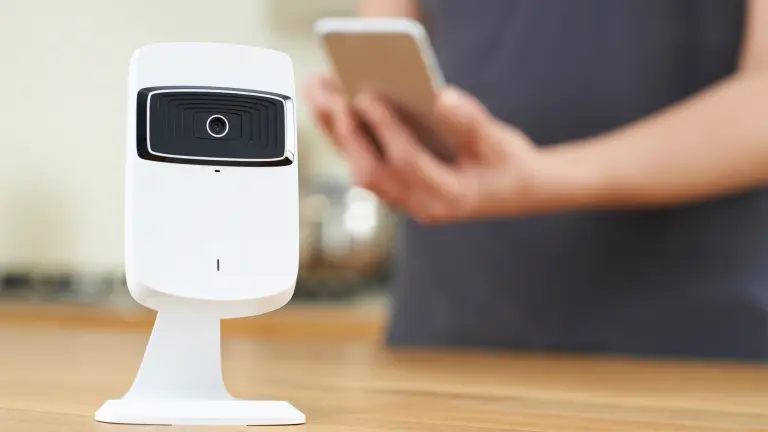Smart camera, a person in the background is holding a smartphone