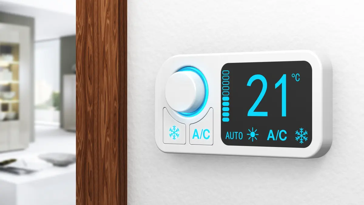 Smart thermostat control unit, blurred living room in the background